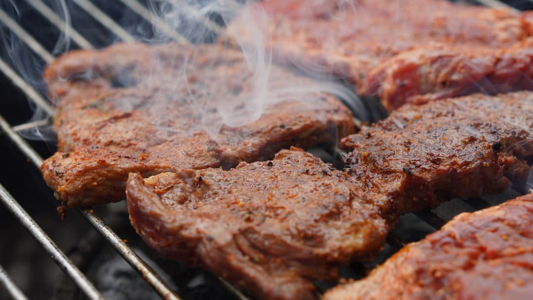 Entraña rubbed in red chile, smoking on the grill
