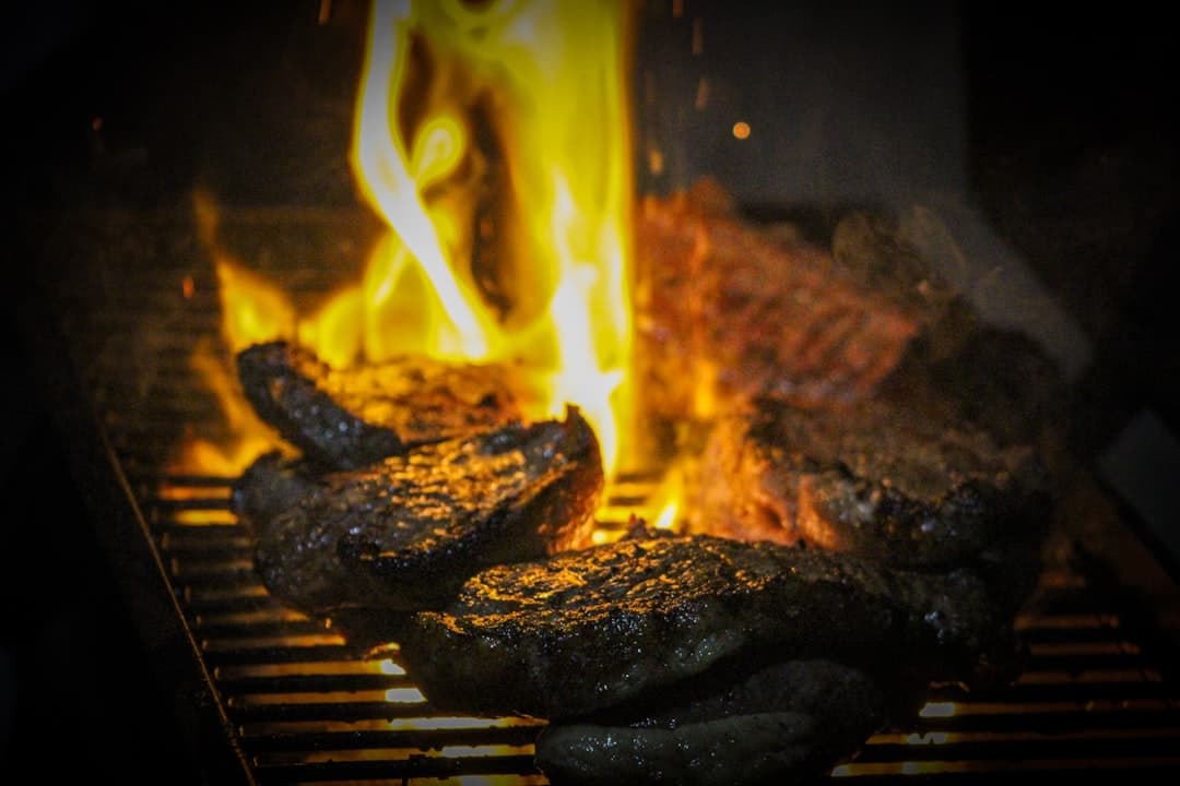 Steaks charring over an open mesquite flame at Bajada